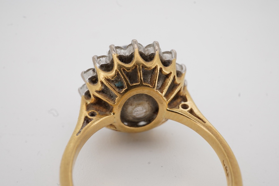 A modern 18ct gold and single stone Tahitian cultured pearl and diamond set circular cluster ring, size O, gross weight 7 grams.